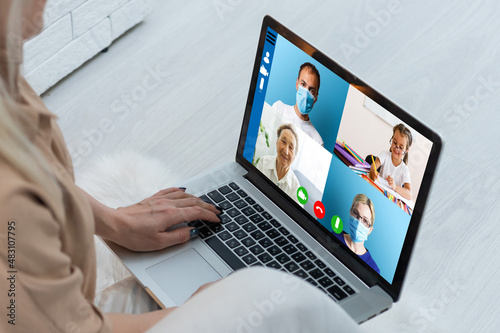 Close up of young female talk on video call consult with diverse doctors colleagues, woman patient have online consultation with GP or physicians, medical nurse in Webcam conference with coworkers.