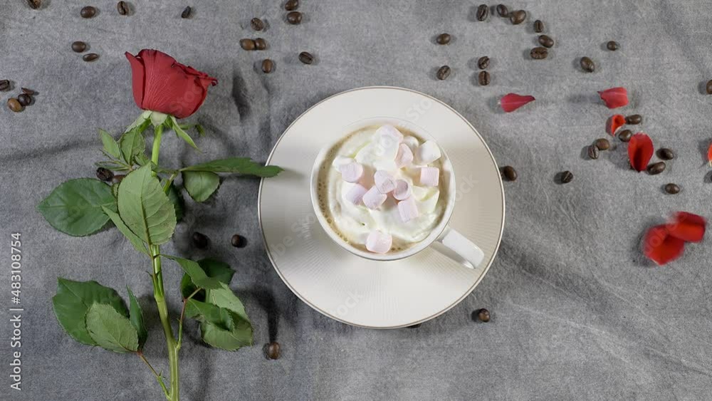 Coffee in a white cup and marshmallows. with a rose on a brown background.
The concept of congratulations, Valentine's Day, mother's day Coffee in a white cup and marshmallows. with a rose on a brown background.
The concept of congratulations, Valentine's Day, mother's day