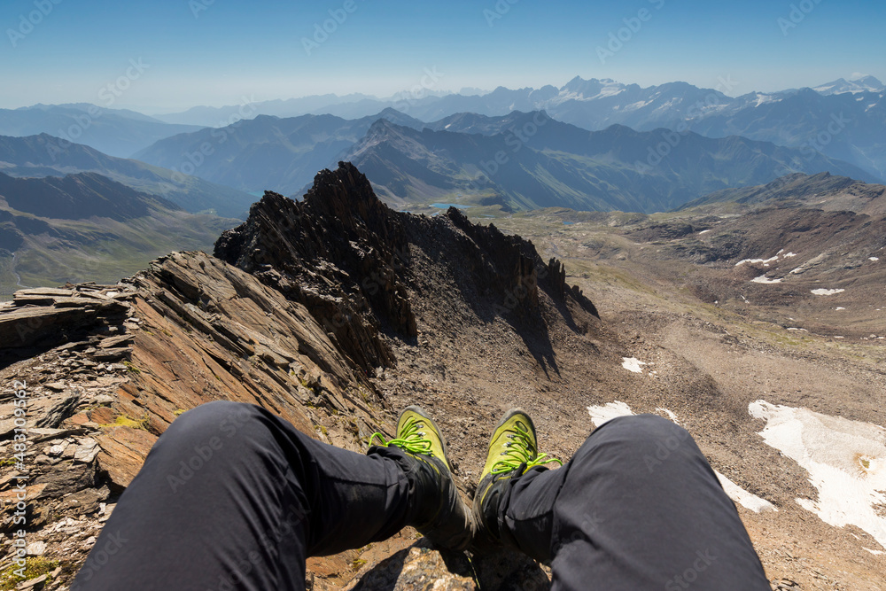 Fototapeta premium Mountains range panorama with legs and alpine boots in Italian alps, Stelvio National Park, Lombardy.