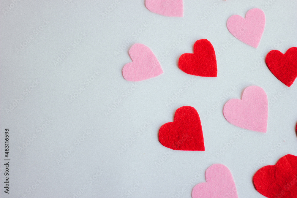 Fototapeta premium Paper hearts over the wight background. Abstract background with paper cut shapes.