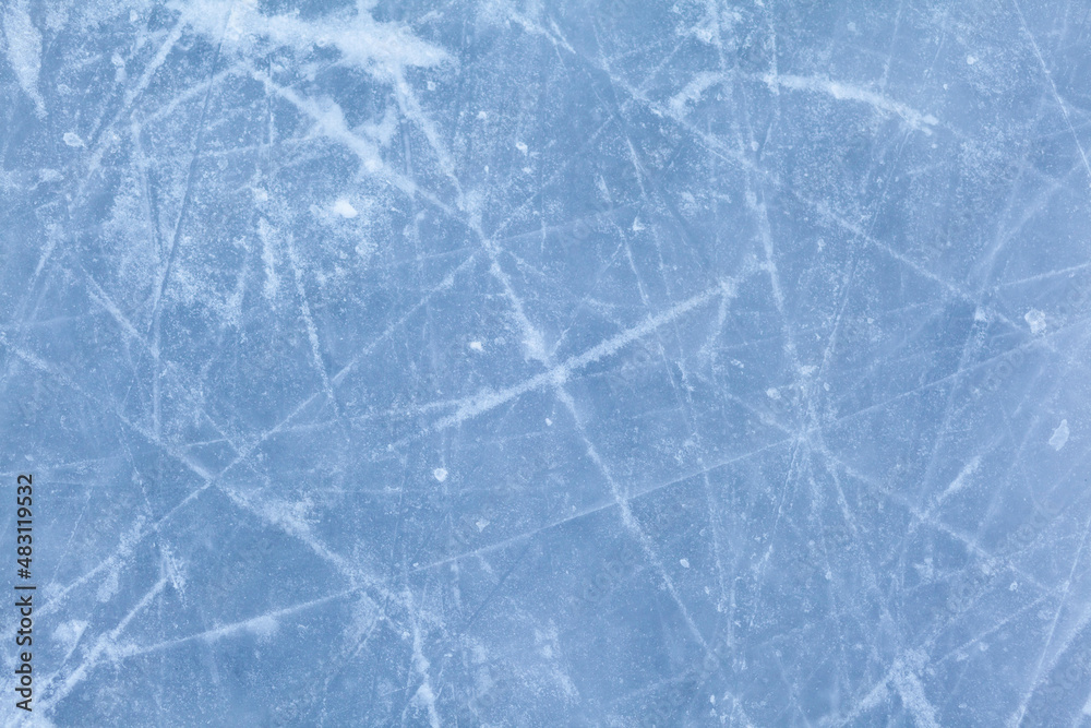 Empty ice rink with skate marks after the session outdoor. skating ice rink texture covered with snow in daylight. Close up of blue ice rink floor, copy space Empty ice rink with skate marks after the session outdoor. skating ice rink texture covered with snow in daylight. Close up of blue ice rink floor, copy space