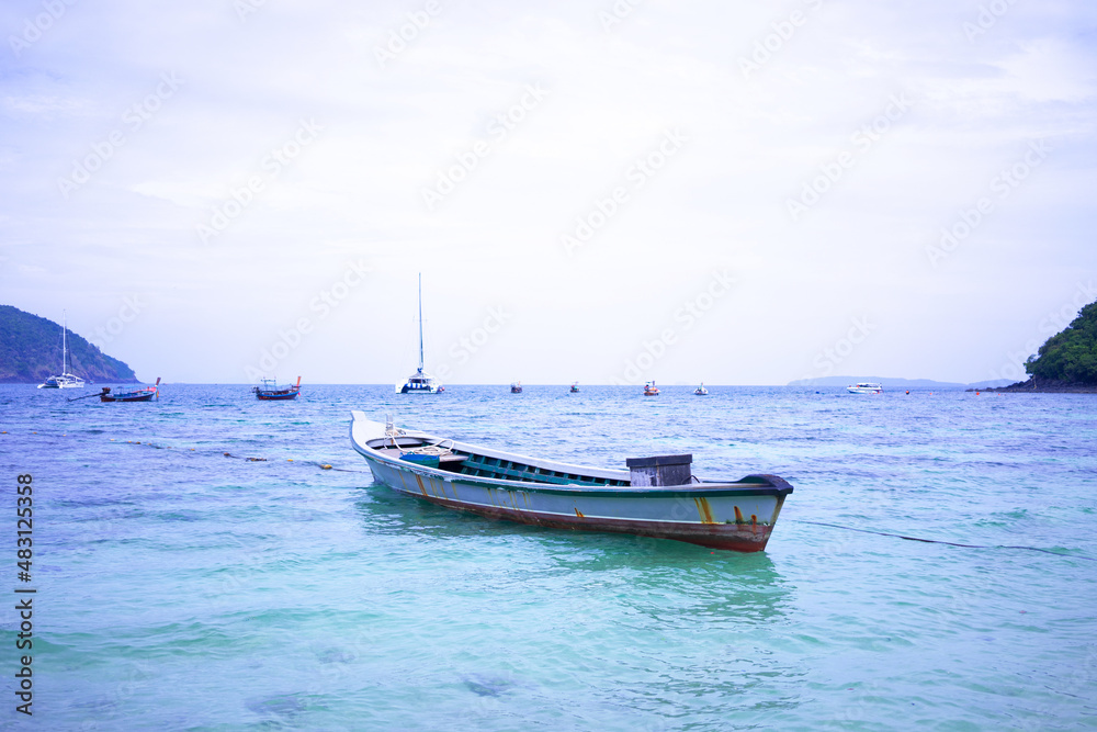 Island in the middle of the sea and boats moored in the sea