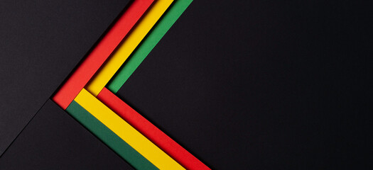Black History Month color background. African American history month celebration. Abstract red, yellow, green color flag on black paper background