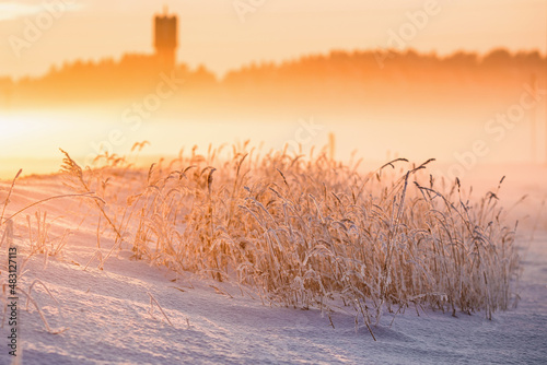 winter landscape with snowy bends in the sunset