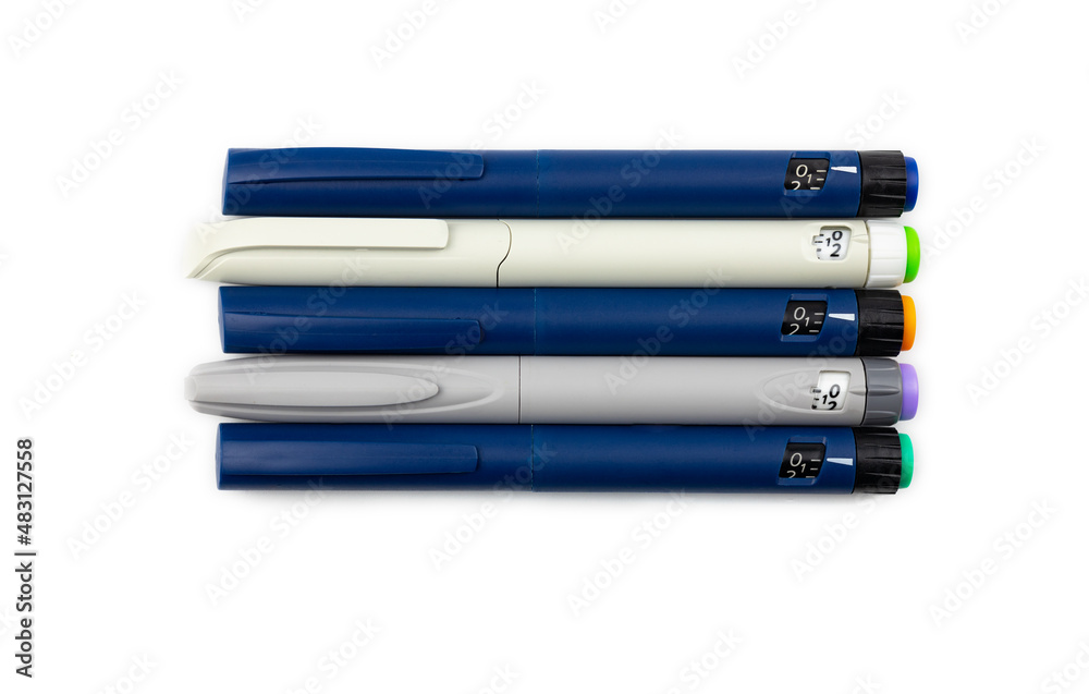 colored insulin pens on a white background, top view. colored insulin pens on a white background, top view.