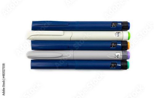 colored insulin pens on a white background, top view. 