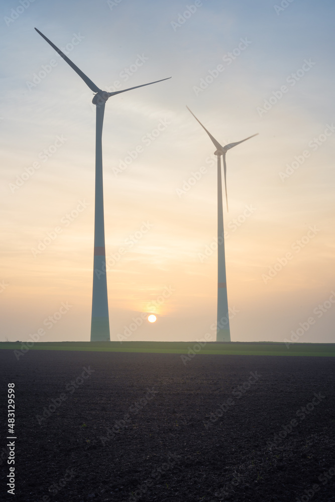 wind turbines in the wind at sunset wind turbines in the wind at sunset