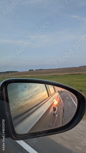 outside summer view in the mirror of a car