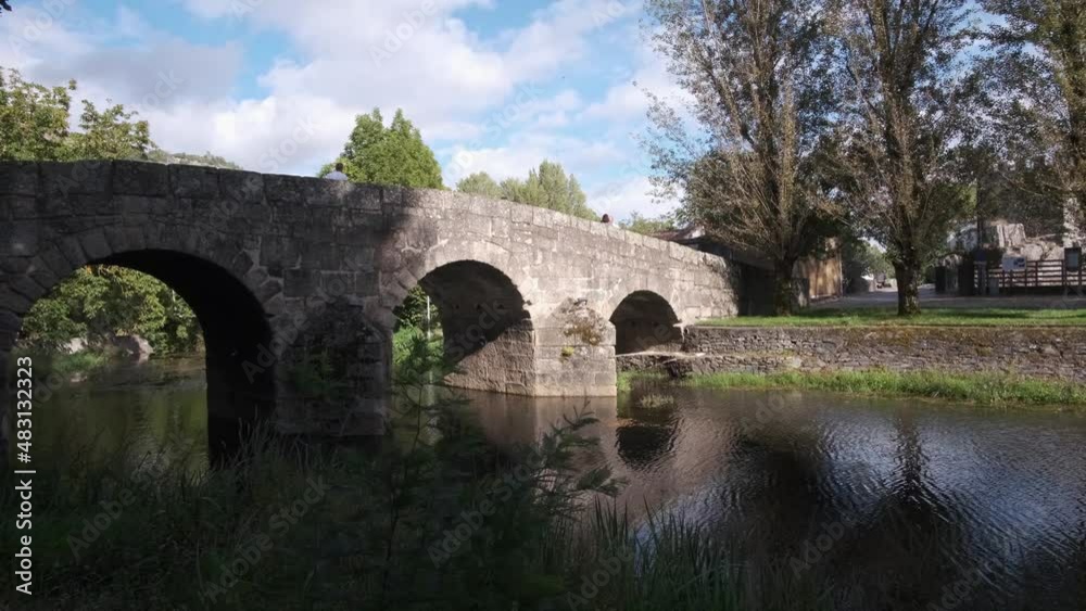 Tourists walk over an ancient Roman bridge in Portugal. Tourists walk over an ancient Roman bridge in Portugal.