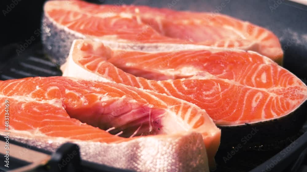 Trout Steaks Pieces on a Frying Pan. Raw Slices with Perfect Texture of Uncooked Red Fish. Sea Food. Freshwater Fish. Healthy Eating Concept Trout Steaks Pieces on a Frying Pan. Raw Slices with Perfect Texture of Uncooked Red Fish. Sea Food. Freshwater Fish. Healthy Eating Concept