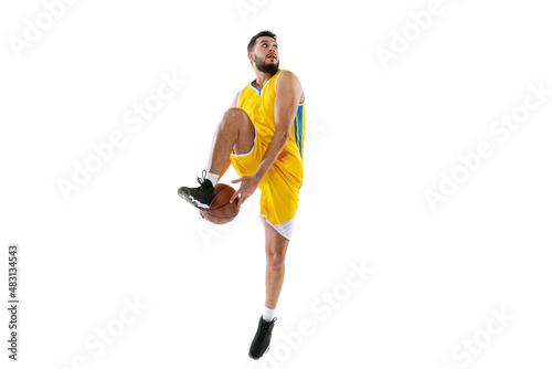 Full length portrait of professional basketball player training isolated on white studio background. Sport, motion, activity, movement concepts.