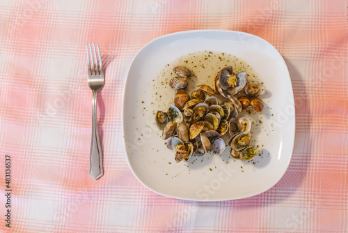 Plate with tasty mollusks served on table photo