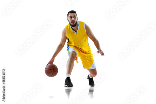 Full length portrait of professional basketball player training isolated on white studio background. Sport, motion, activity, movement concepts.