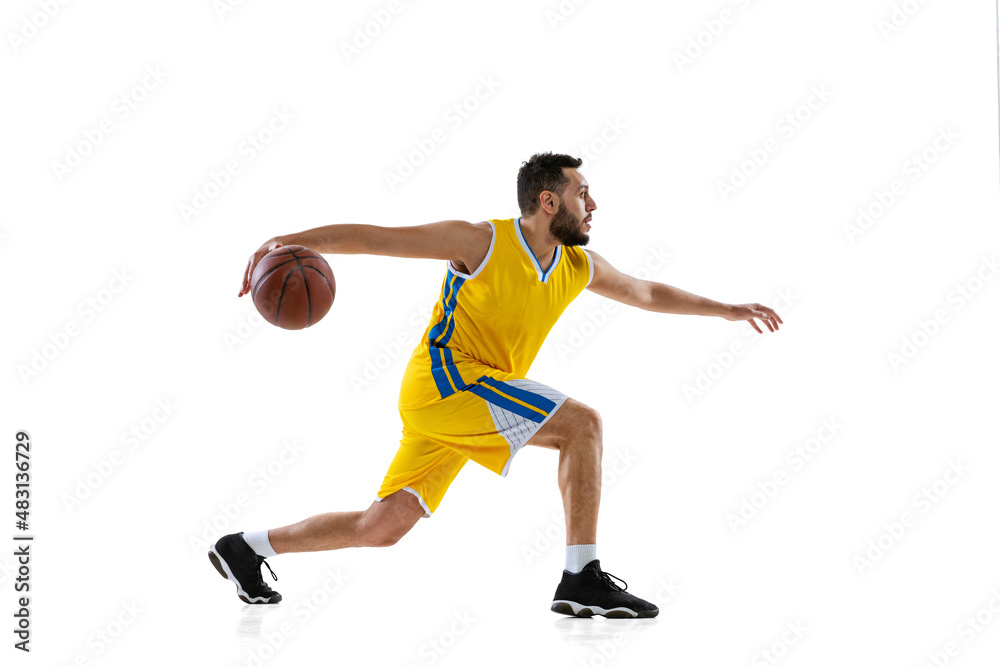 Studio shot of professional basketball player training isolated on white studio background. Sport, motion, activity, movement concepts.