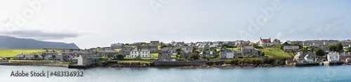Panoramic photograph of Stromness, Orkney, Scotland - Full view of the village viewed from the deck of the ferry. photo