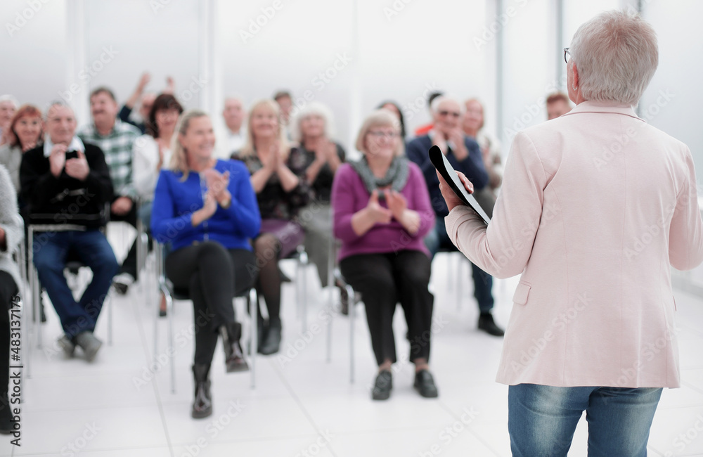 Businesswoman addressing colleagues at office meeting Businesswoman addressing colleagues at office meeting