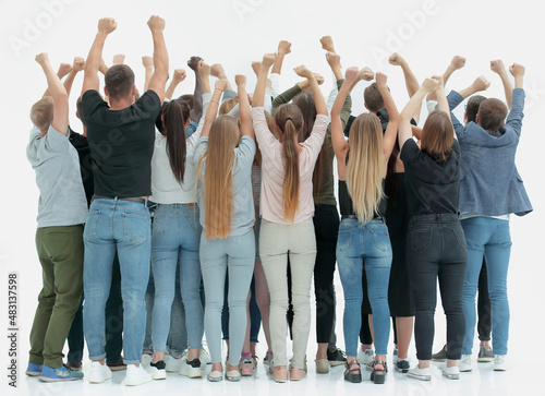 team of happy young people standing with hands up