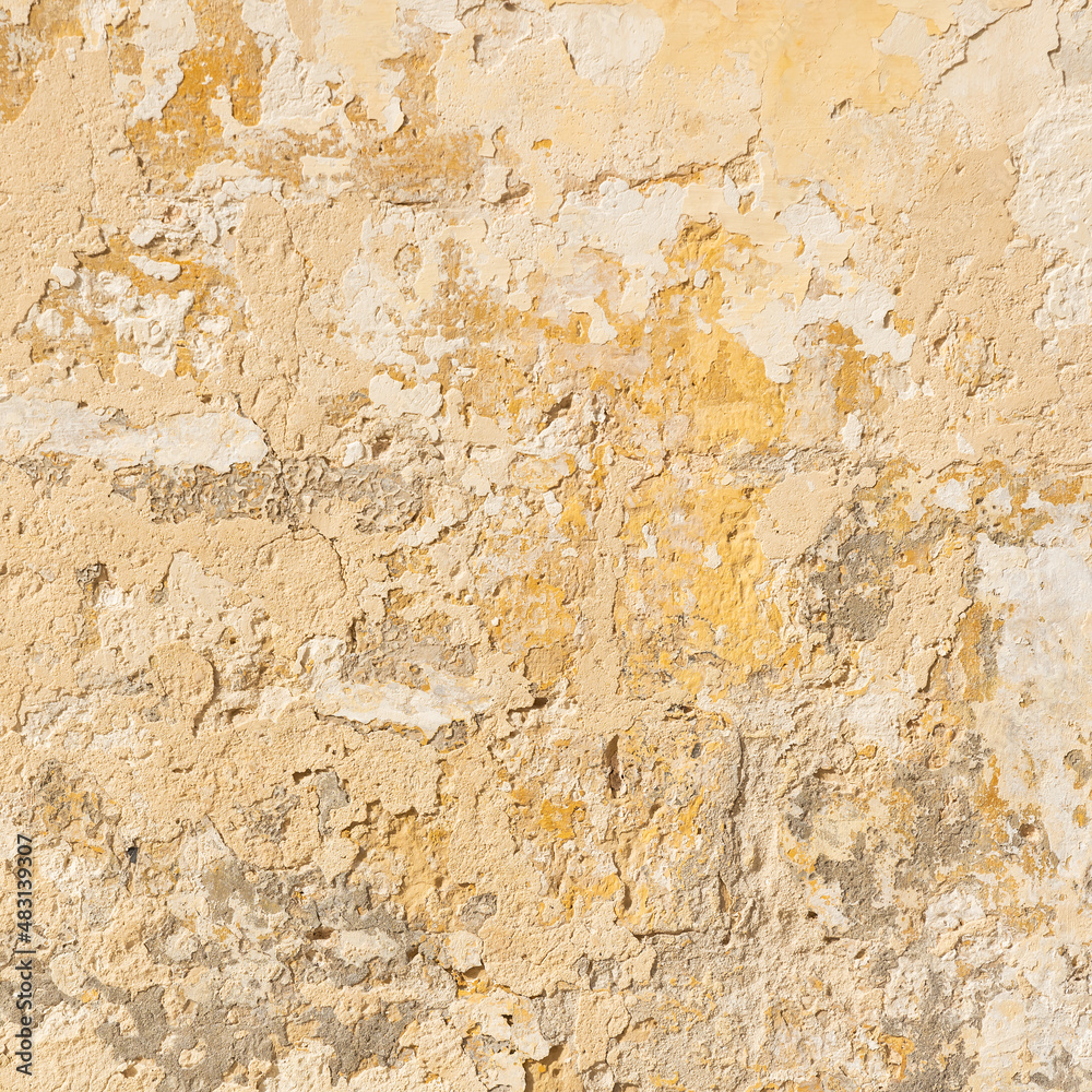 Fototapeta premium Worn yellow textured stone wall, square shot