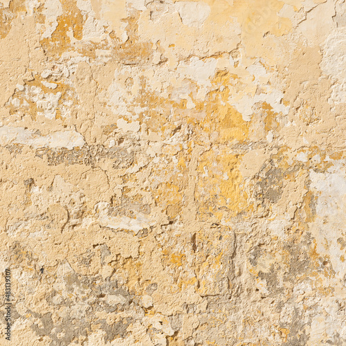 Worn yellow textured stone wall  square shot