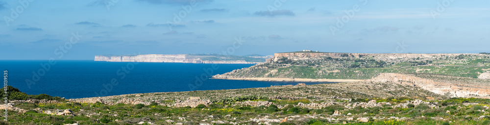 The green and blue coastal line with rocks, bays and mountains around Manikata, Malta