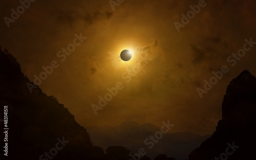 Total solar eclipse in dark red sky above mountains, mysterious phenomenon when Moon passes between planet Earth and Sun