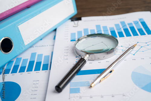 Binder data finance report business with graph analysis in office.