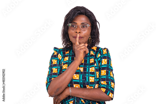 beautiful adult business woman is thinking with crossed arm and raised finger over mouth.