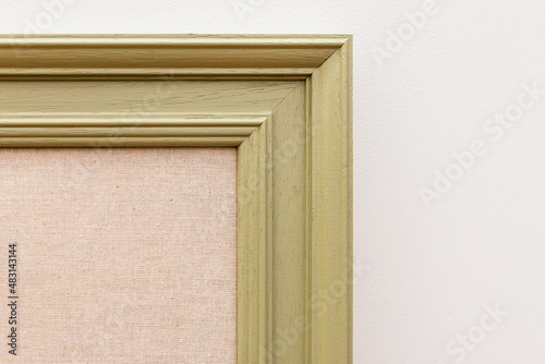 Detail of a noticeboard or cork board painted wooden frame