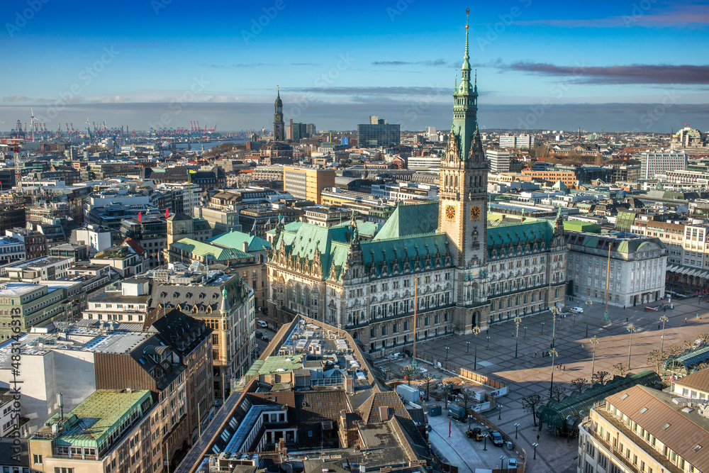 Obraz premium Panoramaaufnahme von Hamburg, mit dem Hamburger Rathaus mit blauem, leicht bewölktem Himmel, von oben aufgenommen (Aufnahme vom Januar 2022)