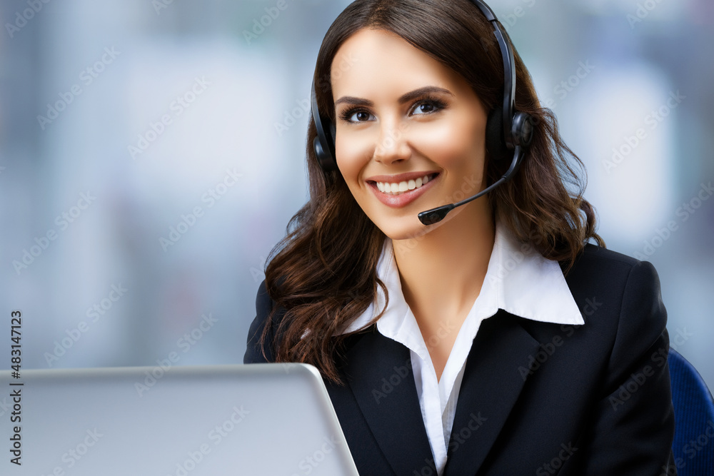 Call center. Portrait image of customer support advertiser sale operator in headset. Businesswoman or phone worker with laptop computer, inside. Answering service agent, blurred office background. Call center. Portrait image of customer support advertiser sale operator in headset. Businesswoman or phone worker with laptop computer, inside. Answering service agent, blurred office background.