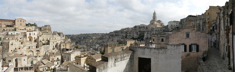 typical street between ancient buildings of the old town that goes up the hill to the Cathedral in Matera