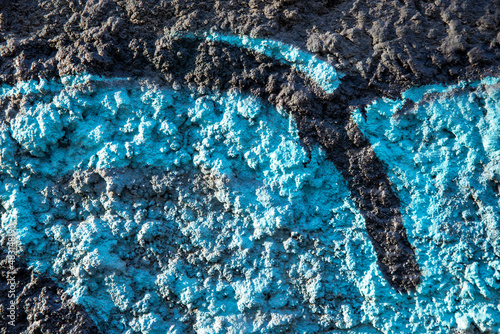 An old colorful concrete wall plastered with traces of old paint, texture.