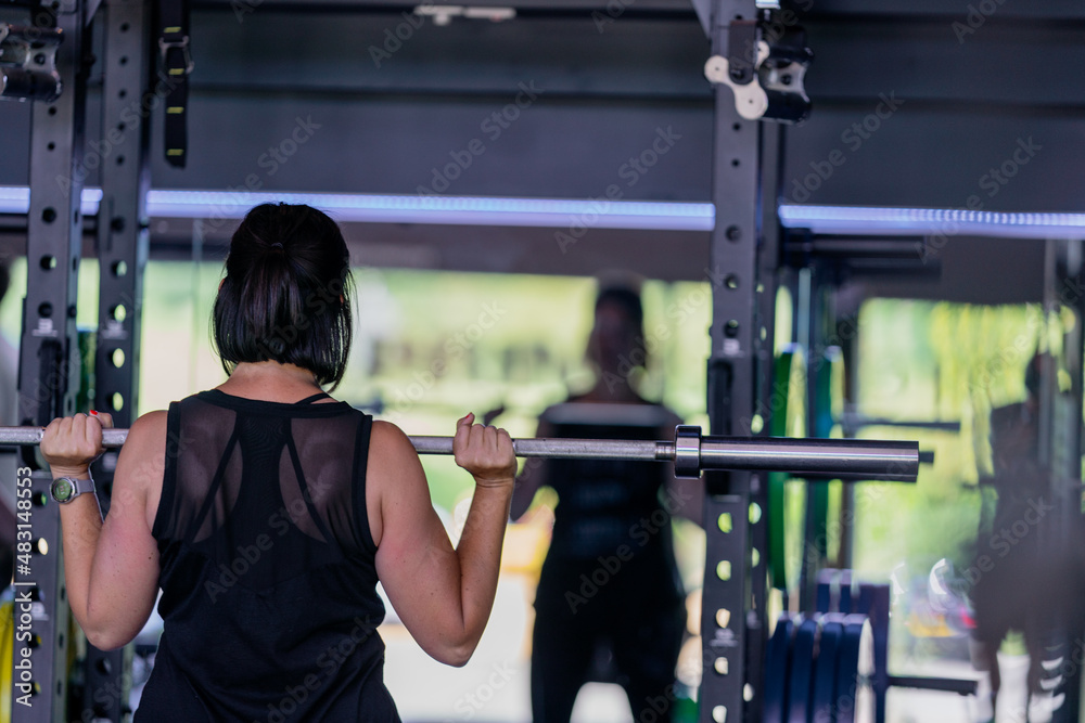 Fototapeta premium Person working out in gym with weights 