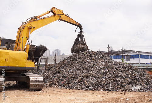 Just another day in the scrapyard. Cropped shot of an excavator sorting through a pile of scrap metal.