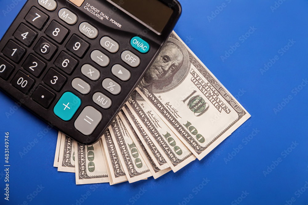 Money and calculator calculation. USD banknotes and a calculator. Planning budget, using calculator checking finances, counting bills or taxes, online banking services Money and calculator calculation. USD banknotes and a calculator. Planning budget, using calculator checking finances, counting bills or taxes, online banking services