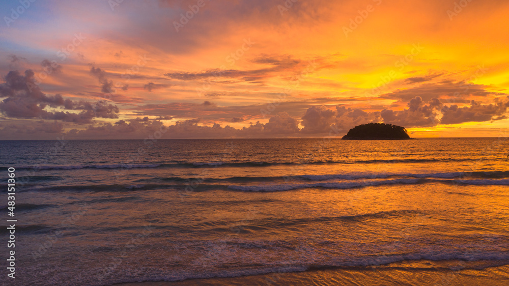Obraz premium .aerial view stunning sunset above Pu island Kata beac Phuket Thailand. .Scene of colorful red light trough in the dark blue sky..Gradient color. Sky texture, abstract nature background.