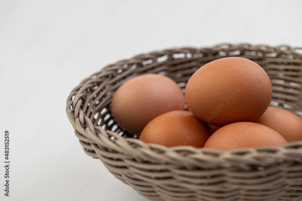 Closeup of fresh brown eggs in Easter basket Closeup of fresh brown eggs in Easter basket