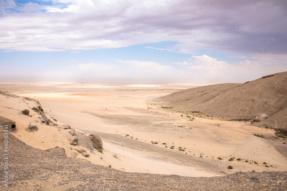 Rock formations in a totally flat desert in the Erongo region, Namibia.