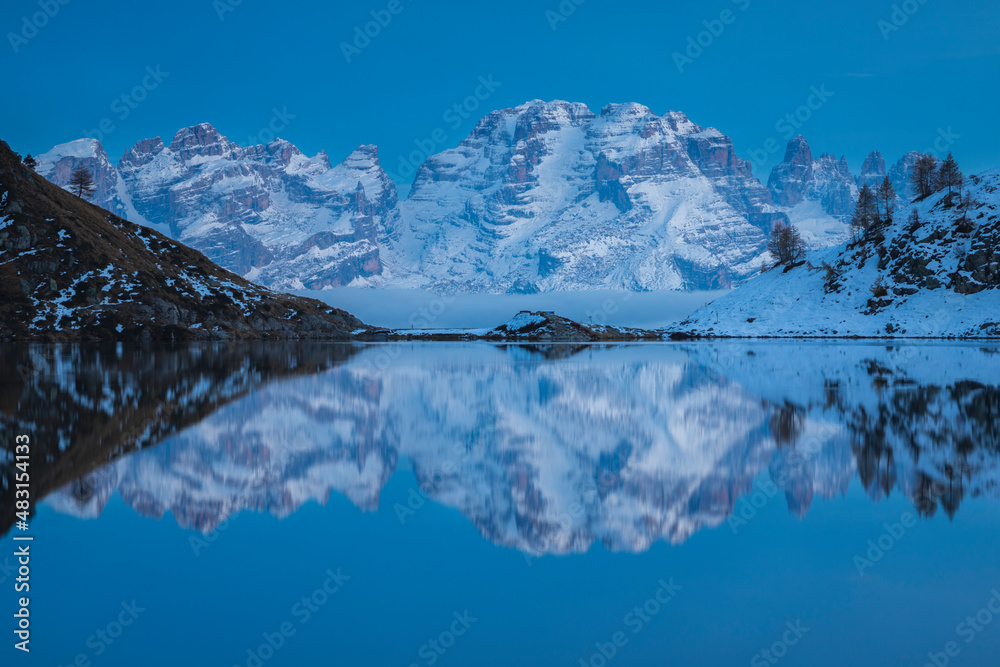 Brenta Dolomites reflected in the Ritorto lake during the blue hour, Adamello Brenta Natural Park, Trentino, Italy.