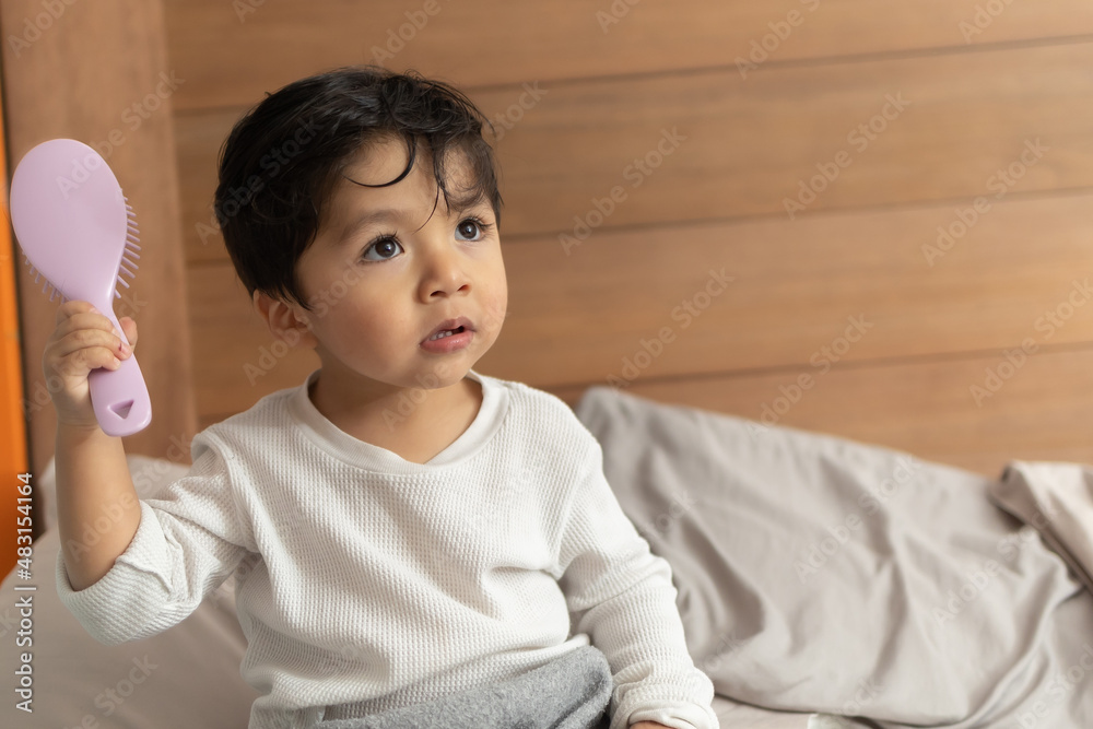 Mexican baby combing after shower on bedroom Mexican baby combing after shower on bedroom