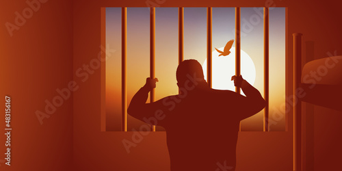 Concept du prisonnier enfermé dans sa cellule, qui regarde un oiseau s’envoler derrière les barreaux. photo