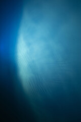 blue background of  dark wall illuminated by electric light