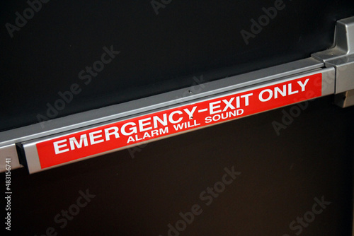 Emergency exit only alarm wall push handle on a black security door