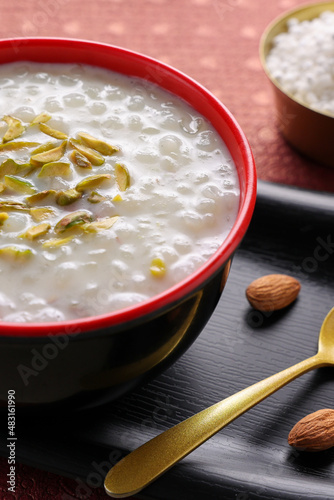 Sabudana Kheer thick pudding with tapioca pearls sago dessert from cassava root Indian sweet mithai  chowari payasam for Mahashivratri Ram Navami Diwali festival. photo