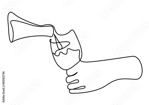 a hand holding the glass and a hand pouring the drink from the bottle
