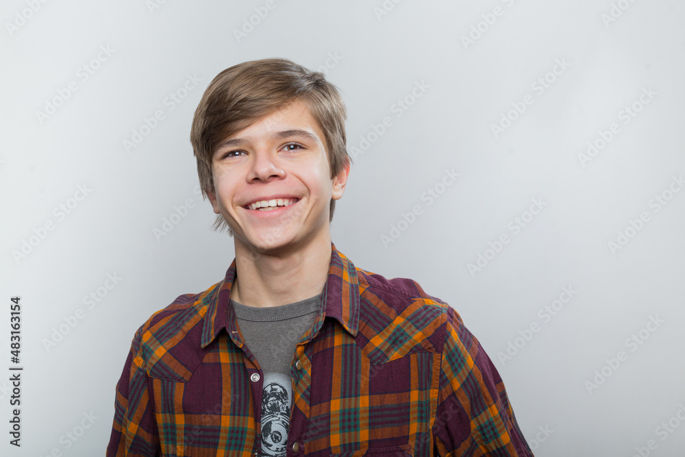 Emotional portrait of a teenager in a plaid shirt Emotional portrait of a teenager in a plaid shirt