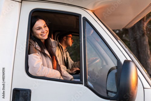 Active and handsome family traveling by the white car in the woods. Happy brunette girl looks at the views. Stock photo