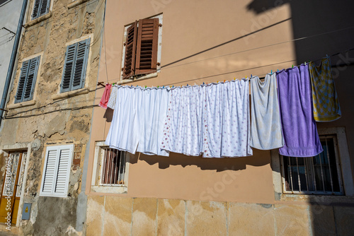 Laundry hanged on the rope to dry outside in the narrow and old streets of Rovinj, Croatia © Miroslav Posavec