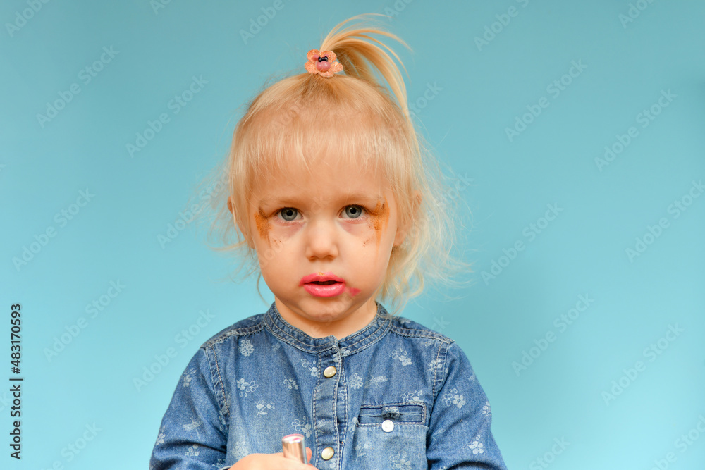 A portrait of a child who put on parental makeup on his own. Small children and high fashion. A portrait of a child who put on parental makeup on his own. Small children and high fashion.