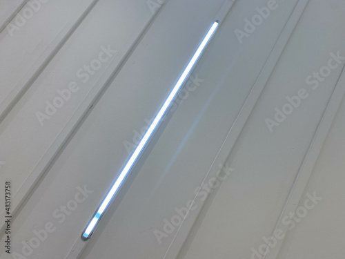 Led light blue light science technology background. Abstract of blue led light of ceiling. Diagonal shape or Light straight line joining opposite corners. Fluorescent lights on ceiling in room